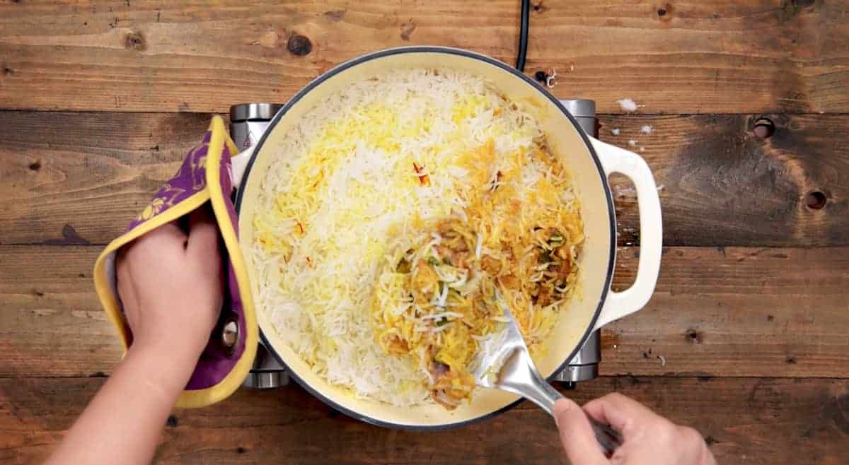 Cooked chicken biryani in Dutch oven.