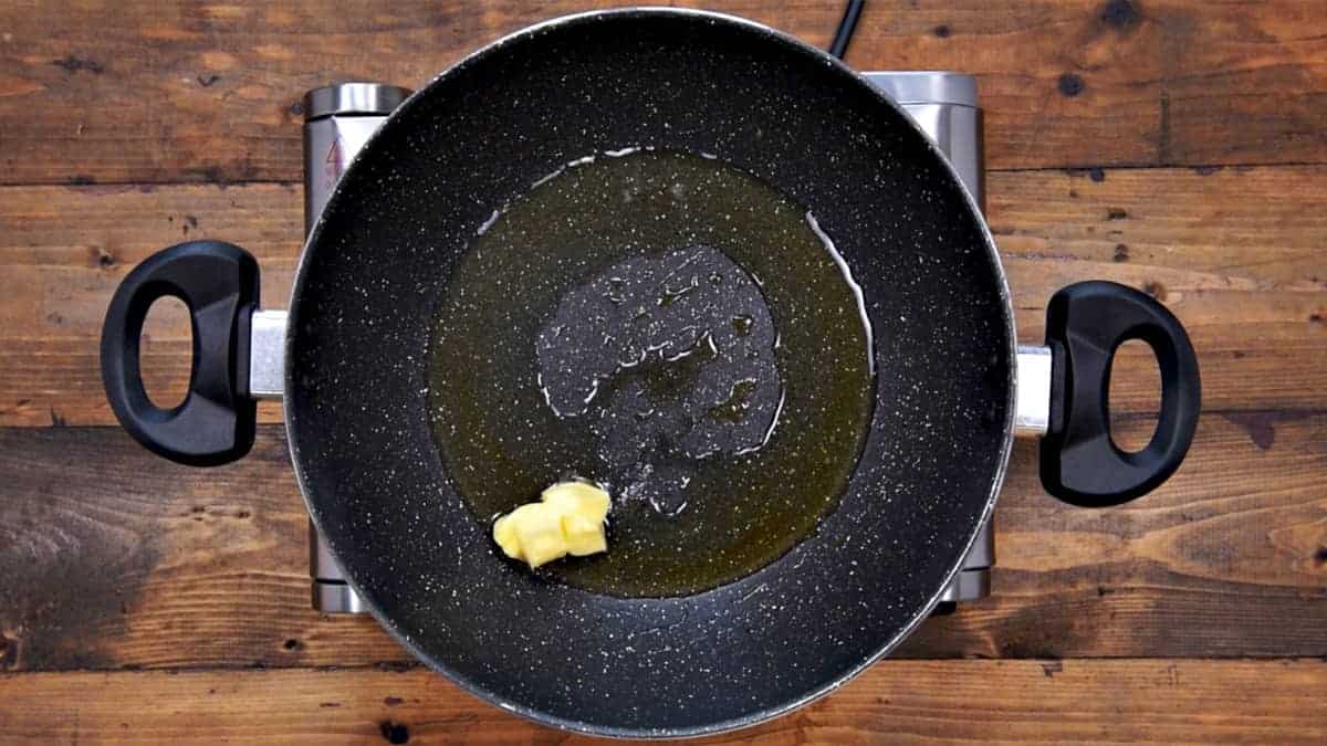 Oil and butter heating in pan.
