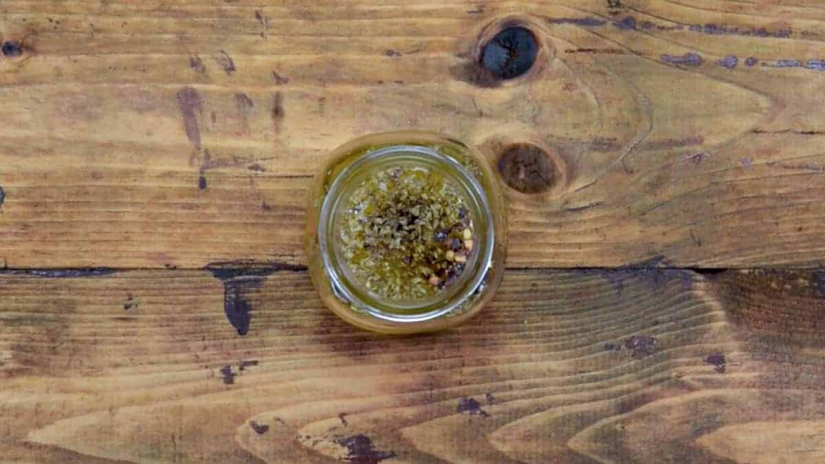 Lemon Dressing ingredients added into glass jar.