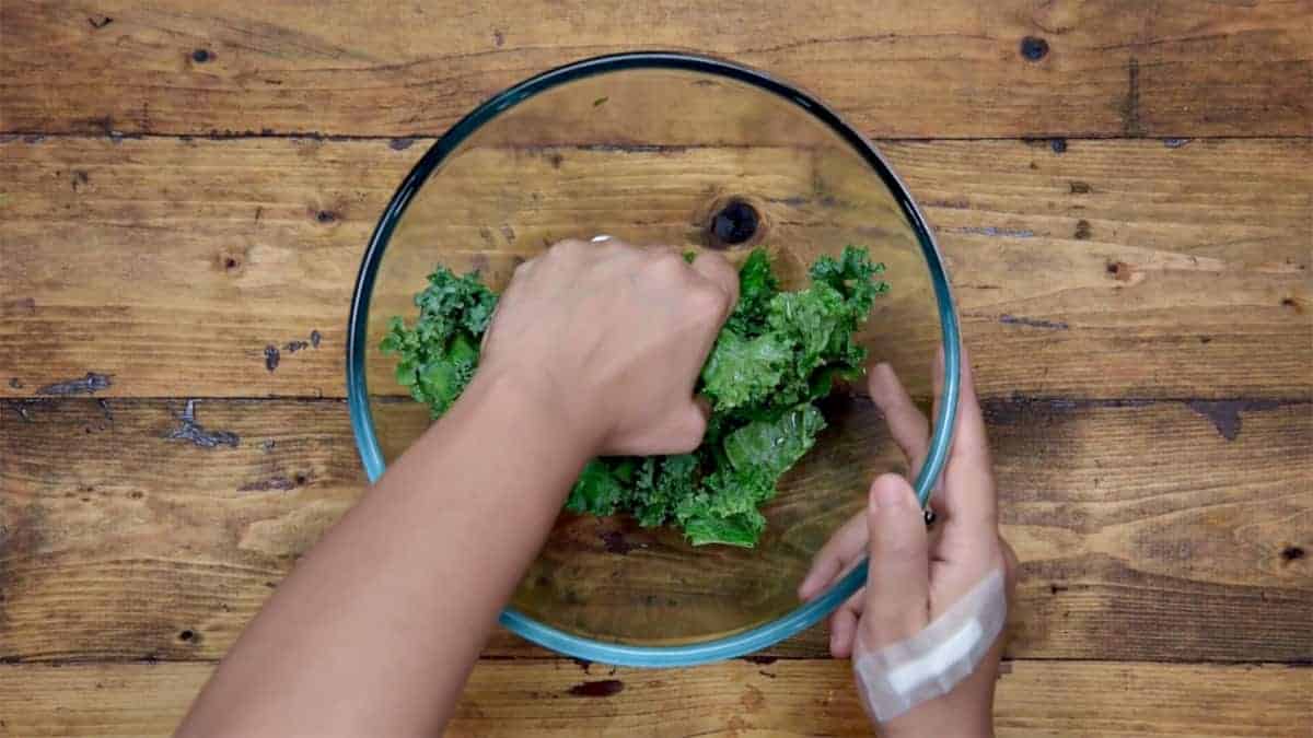 Softening the Kale leaves by massaging it using hands.