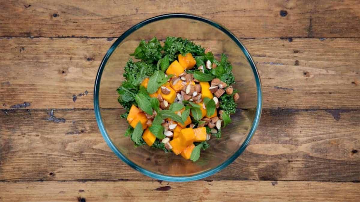 Mango cubes, almonds, fresh mint leaves, salt and pepper added to softened Kale.