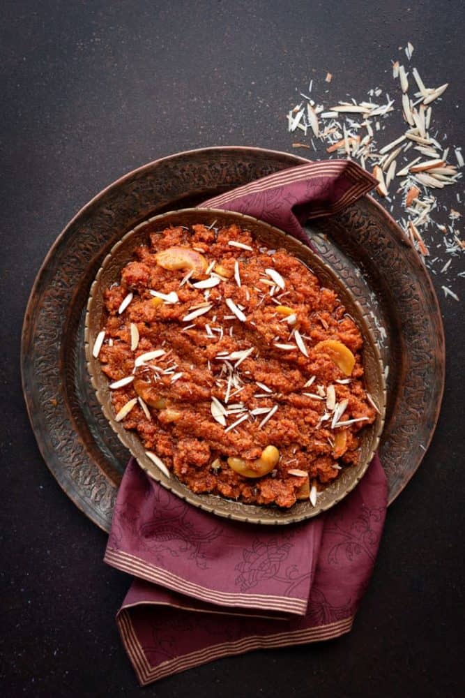 Overhead shot of instant pot gajar halwa in oval brass plate.