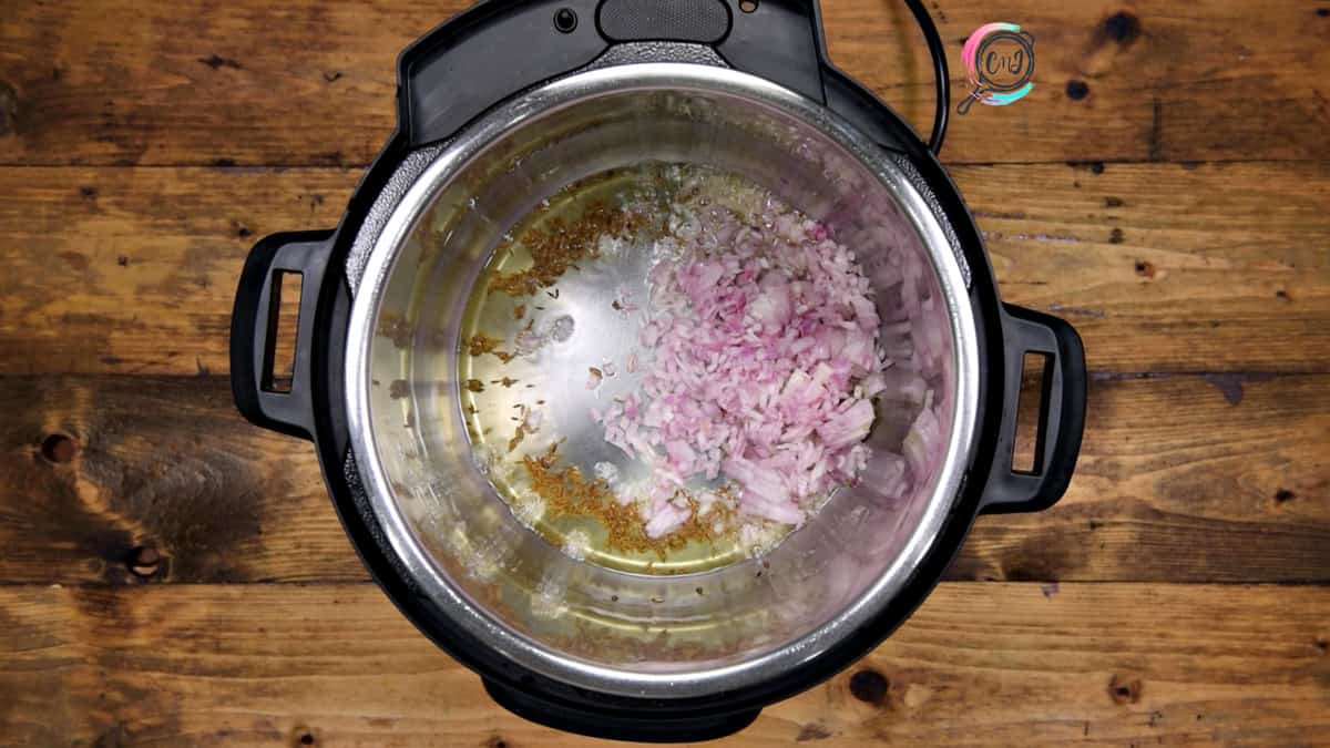 Chopped onions added in steel pot in Instant Pot.