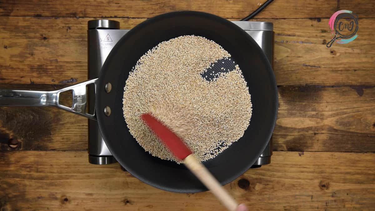 Toasting the sesame seeds on low heat stirring continuously with the spatula.