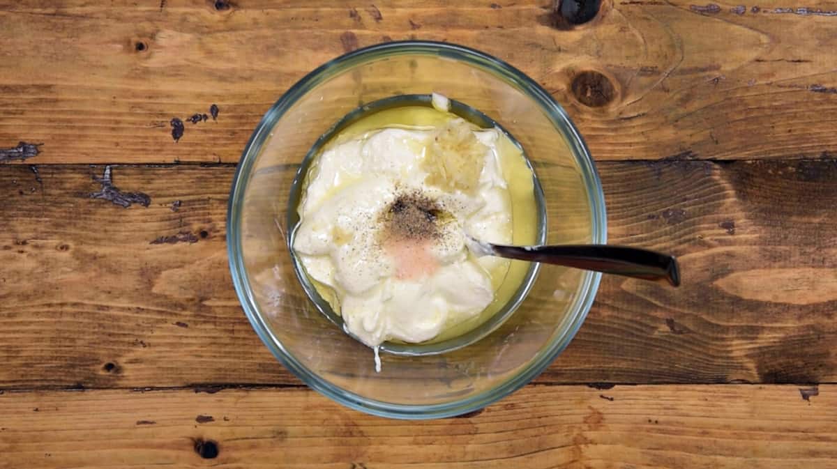 Greek yogurt, minced garlic, olive oil, salt and pepper added in large bowl.