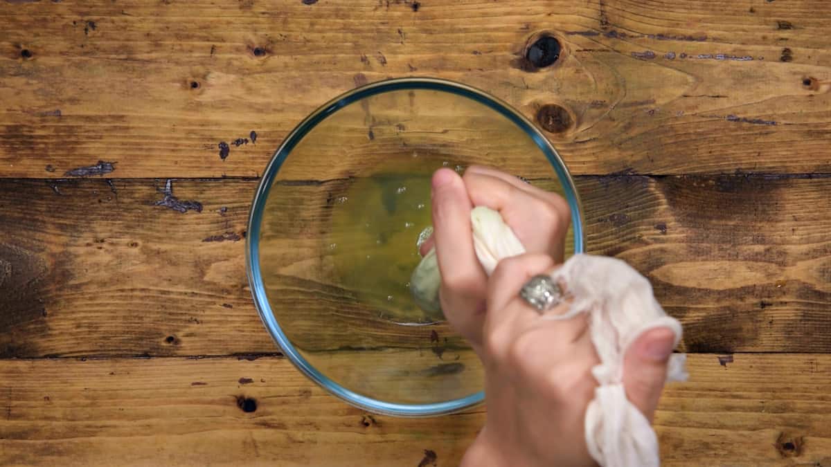 Squeezing out the water from grated cucumber.