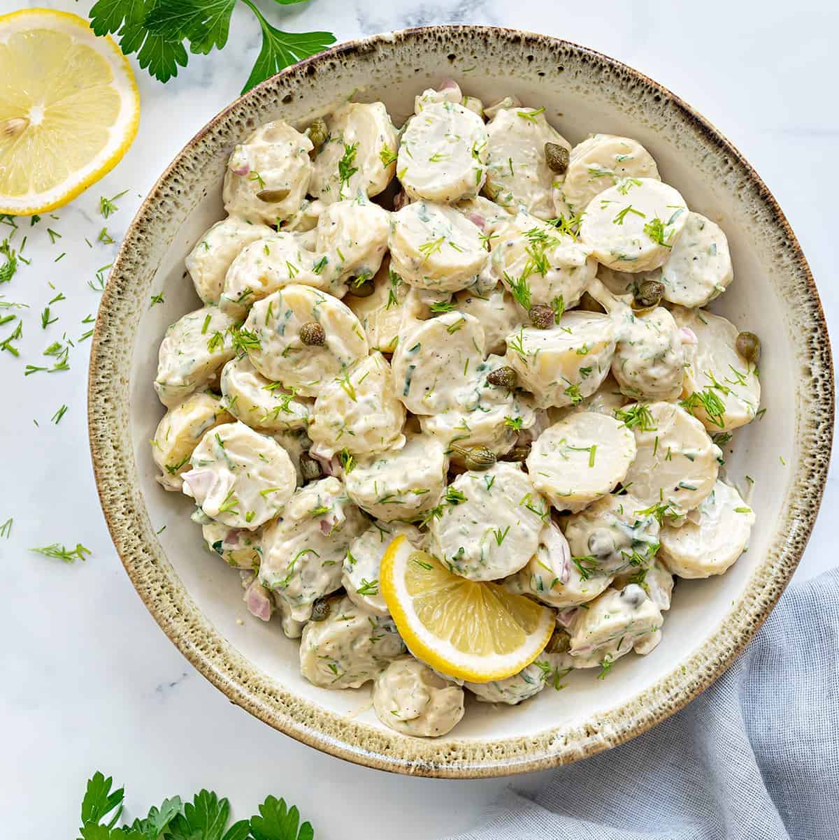 Creamy Lemon Dill Potato salad served in ceramic bowl.