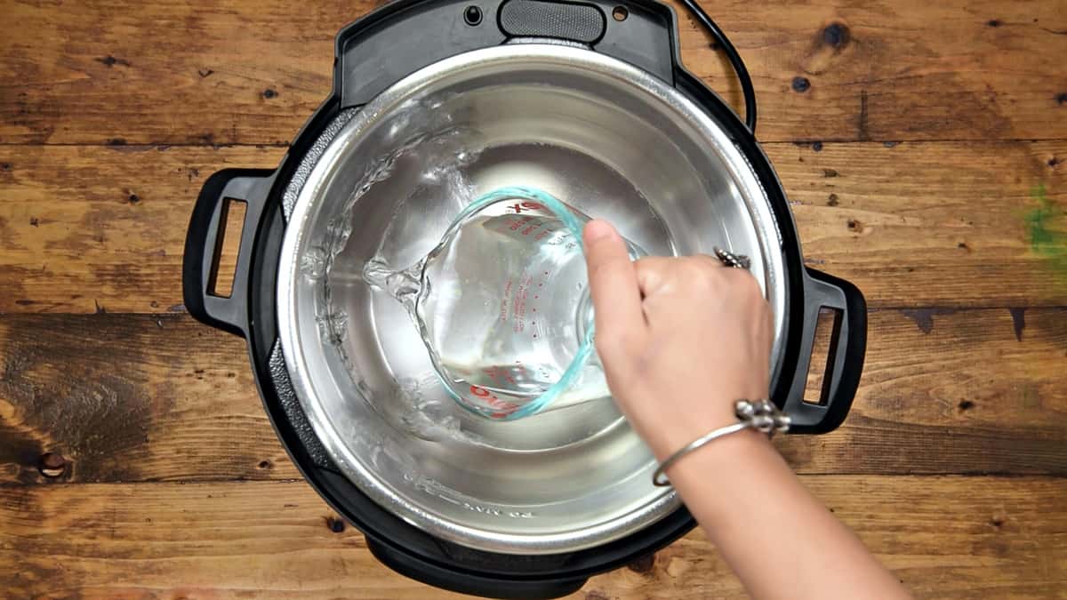 Adding water in the steel insert of Instant Pot.