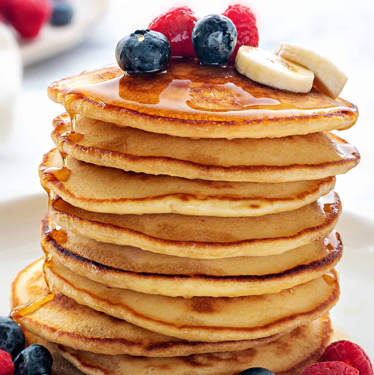 Fluffy pancakes with berries and maple syrup
