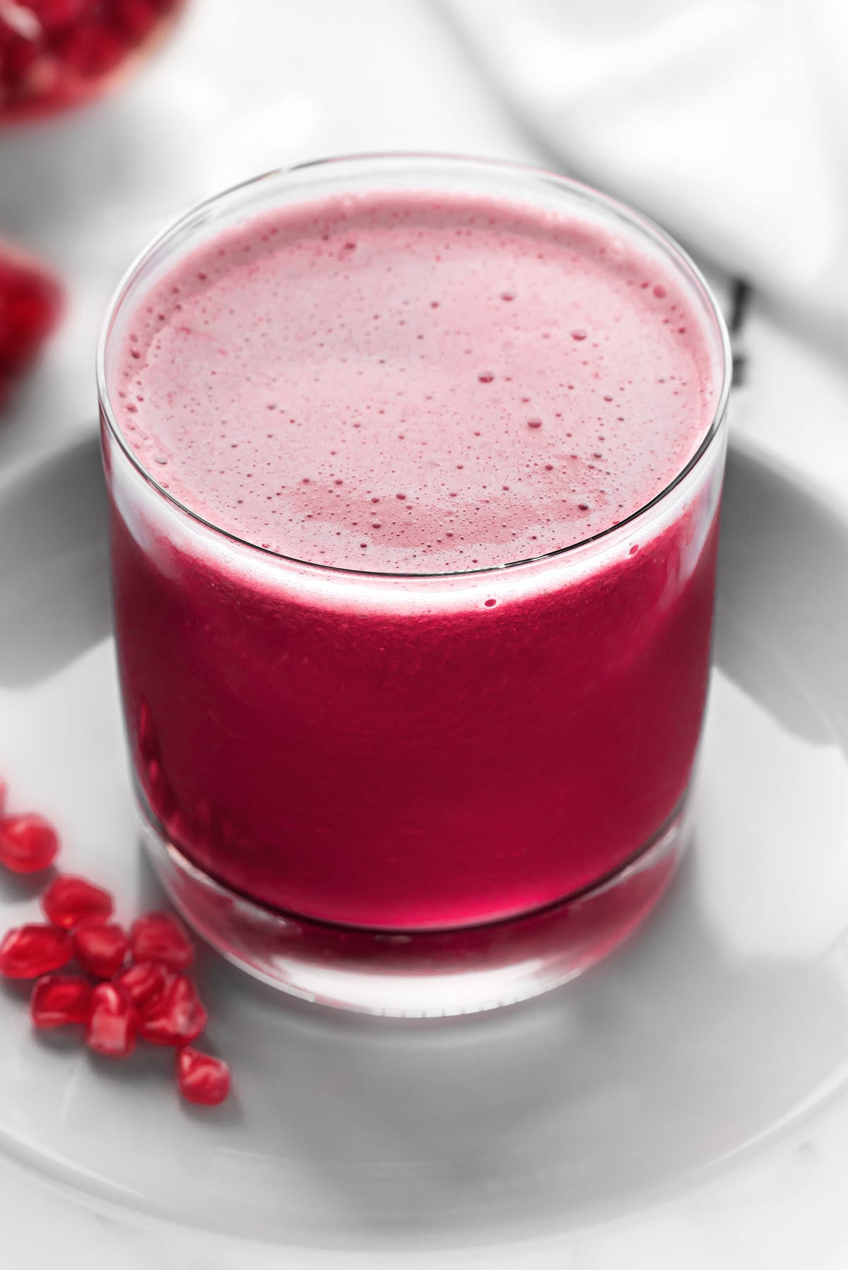 Close up shot of fresh Pomegranate juice served in glass.