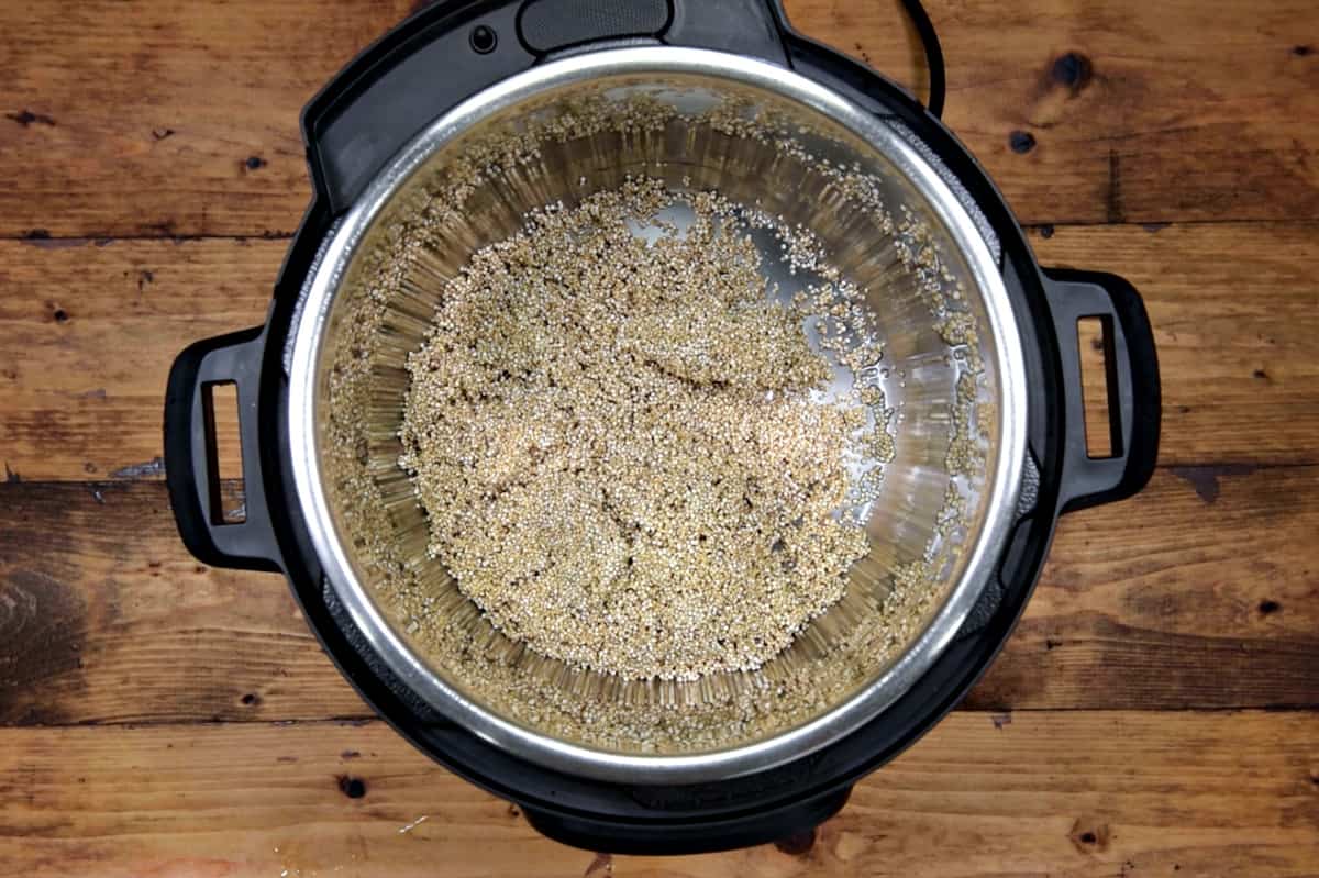 Rinsed and strained quinoa added into the pot.