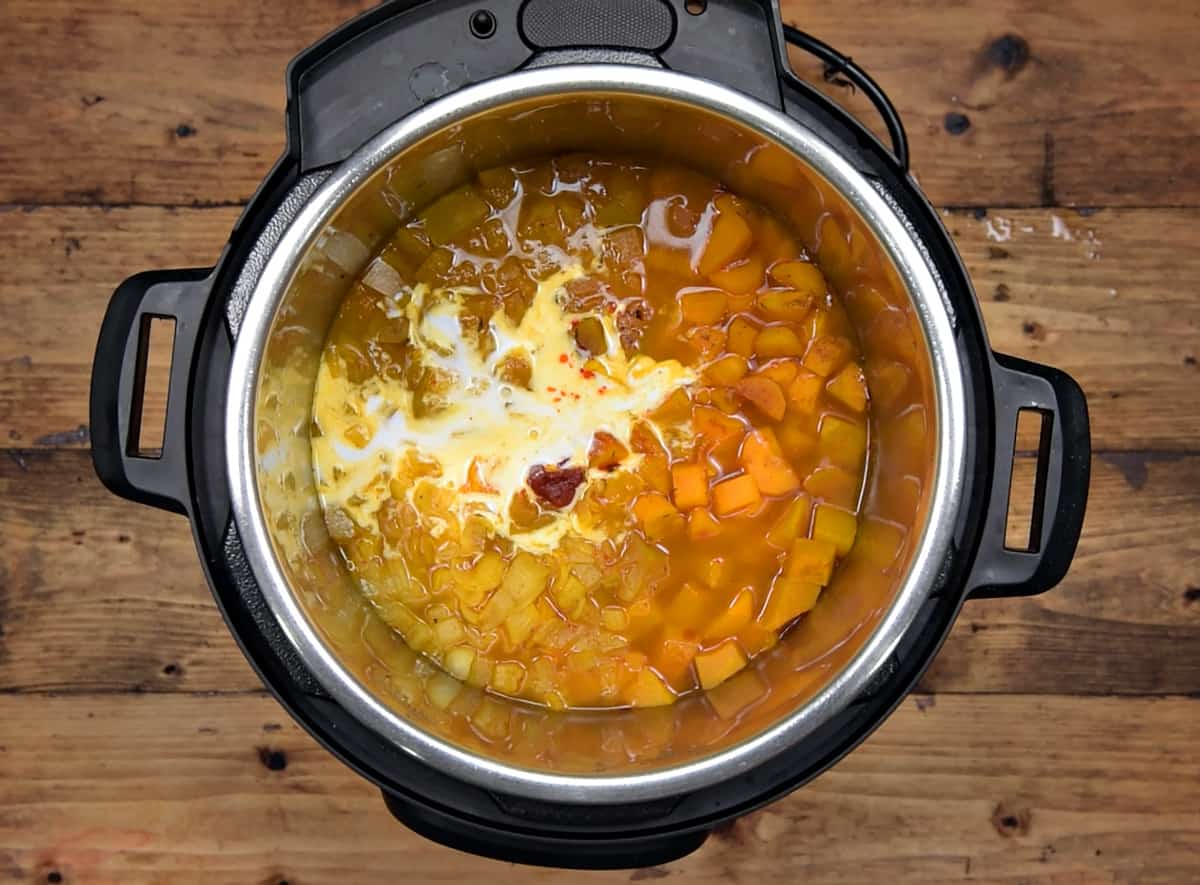 Coconut milk added to the cooked butternut squash in instant pot.