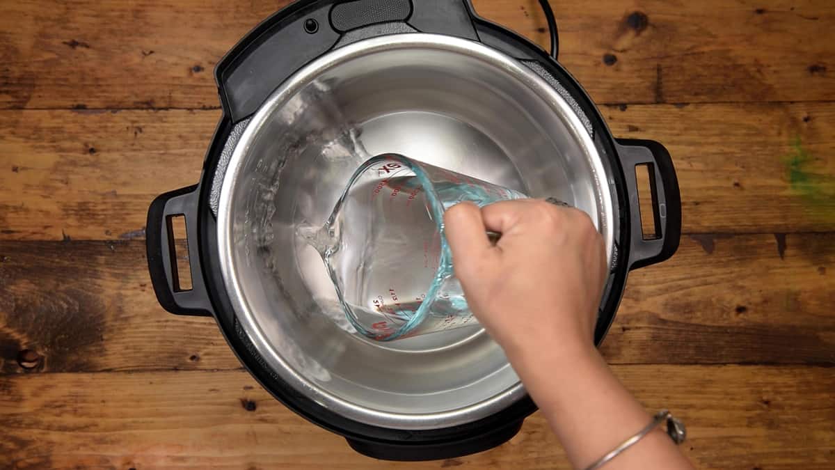 Adding water into steel insert of instant pot.