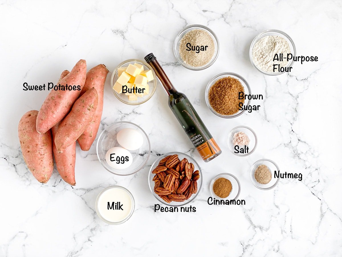 Overhead shot of all ingredients for the recipe kept in small bowls, sweet potatoes stacked on the left.