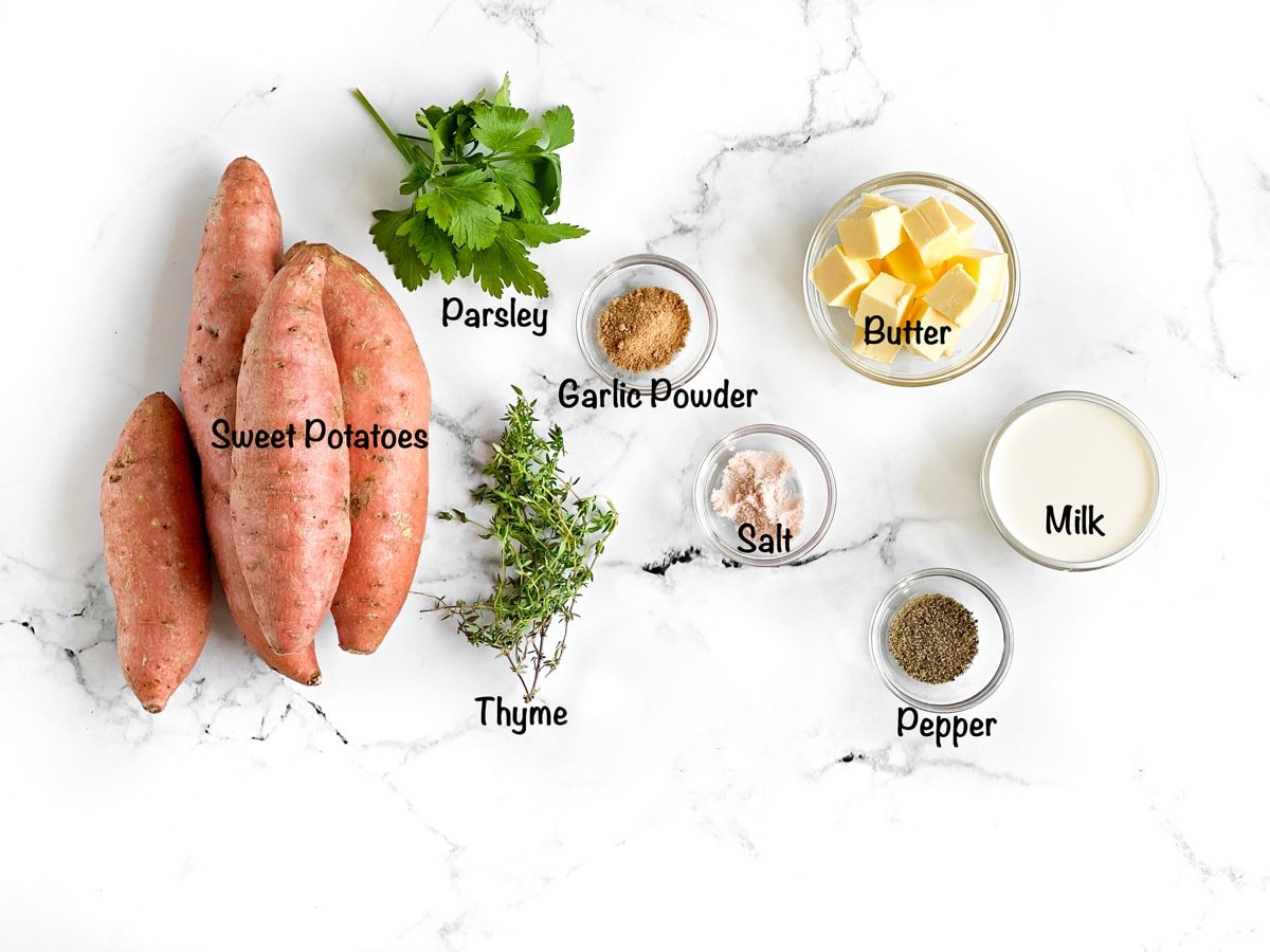 sweet potatoes, parsley, garlic powder, salt, pepper, milk, butter and thyme as mis en place for easy mashed sweet potatoes