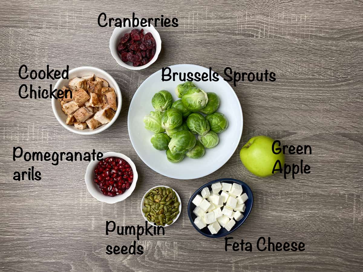 mise en place for shaved brussels sprout salad placed on a plate and in small bowls