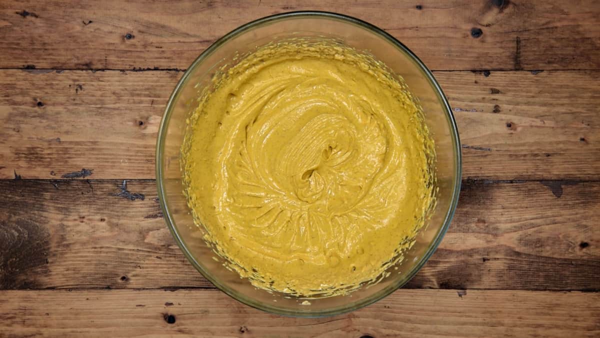 pumpkin cheesecake filling after being mixed in a clear mixing bowl