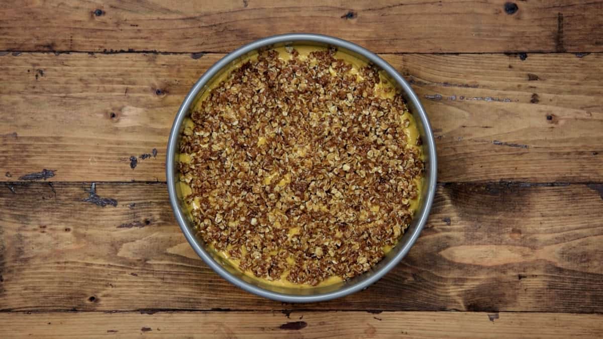 crumble sprinkled over gluten free pumpkin cheesecake before baking