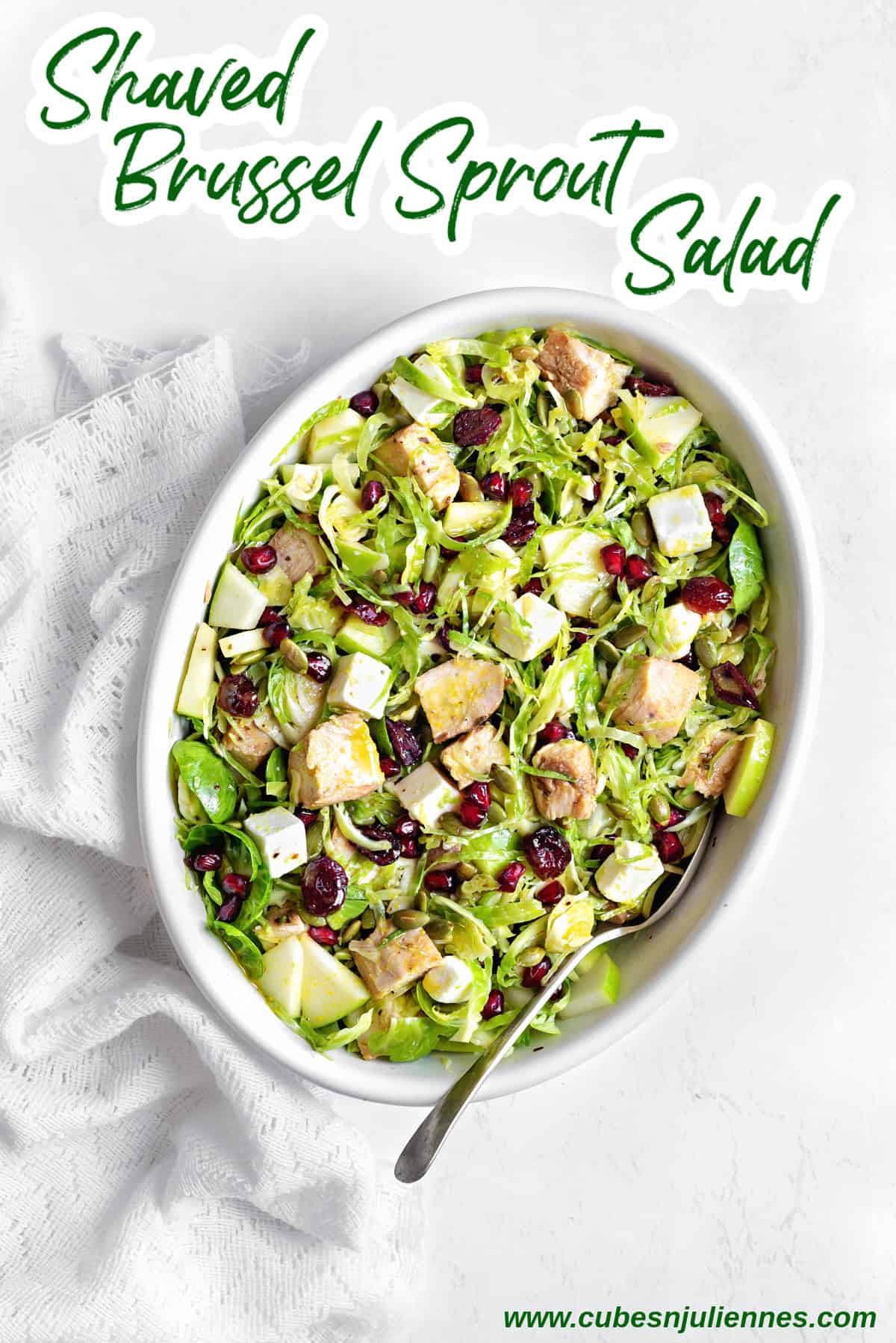 Overhead shot of chicken and shaved brussels sprouts salad served in white oval dish