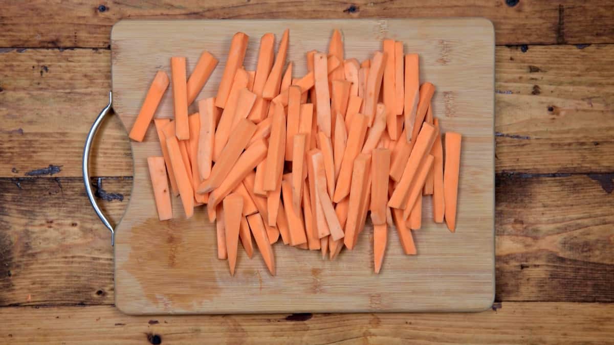 wooden cutting board with sweet potato batons