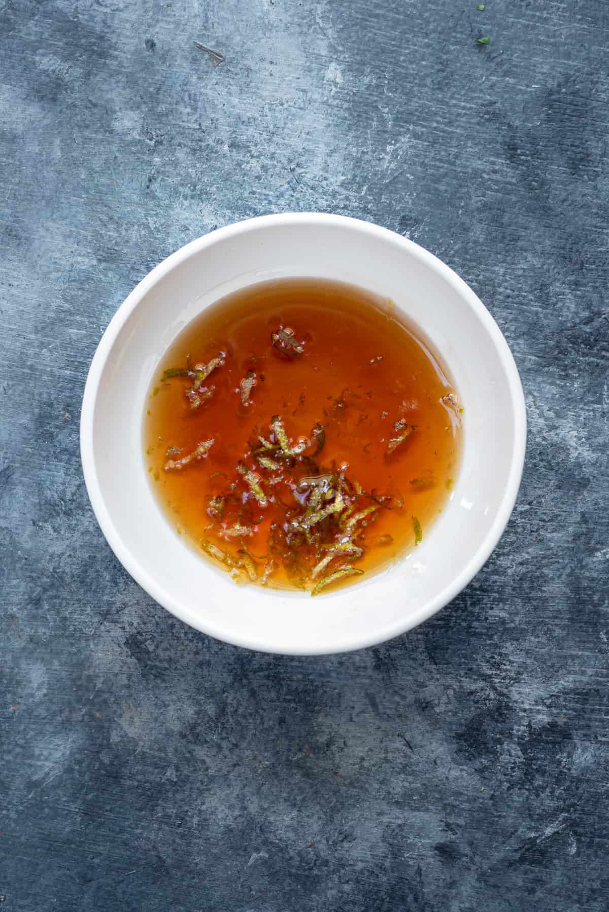 maple syrup, lime zest and lime juice in a small white bowl