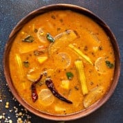 close up shot of vegetable sambar dal in wooden bowl.