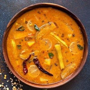 close up shot of vegetable sambar dal in wooden bowl.