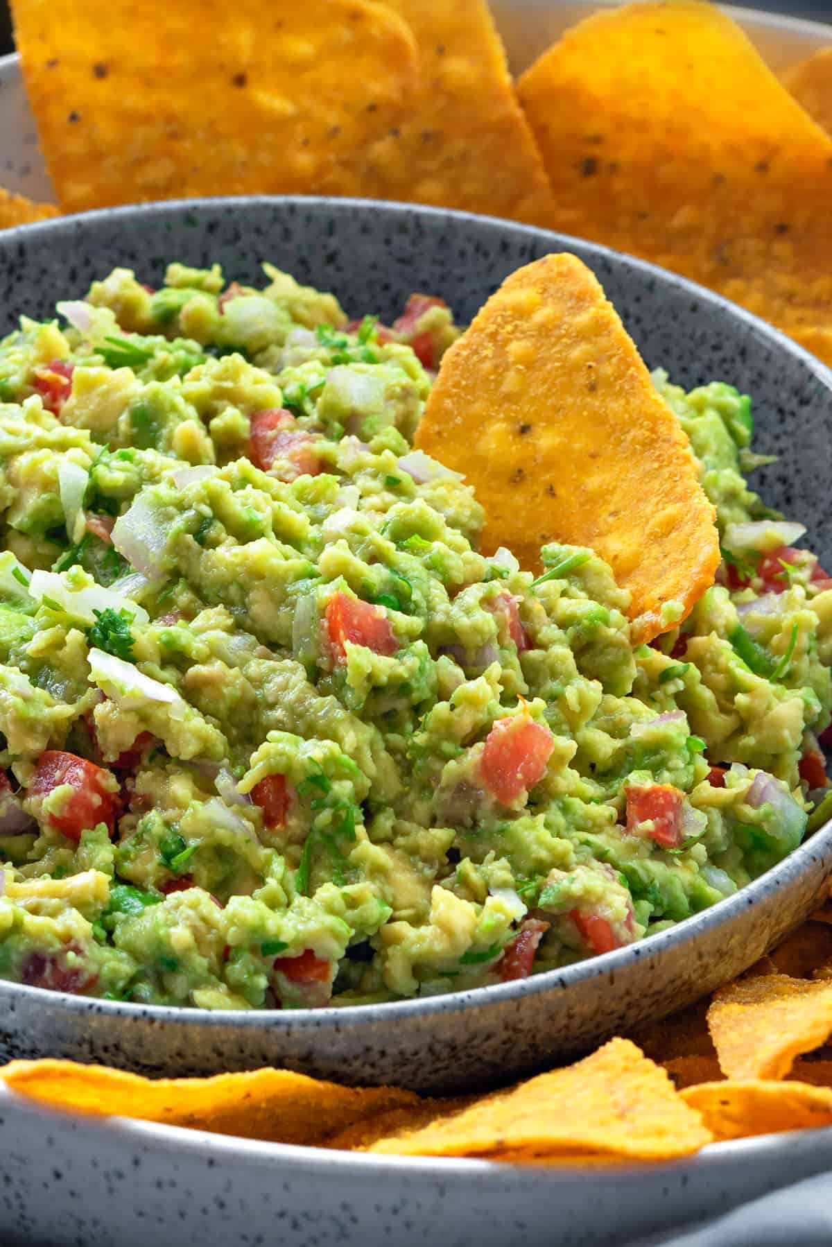 Close up shot of a bowl of chunky guacamole