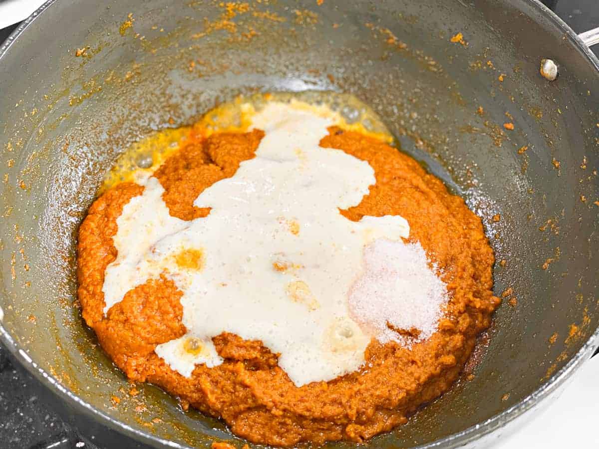 yogurt and salt added to wok with egg masala curry mix