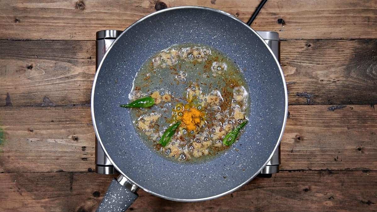 ground turmeric added to pan after   sautéing grated ginger in oil