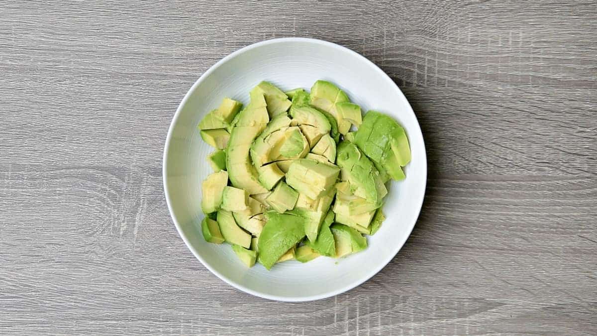 cubed avocado in a white bowl