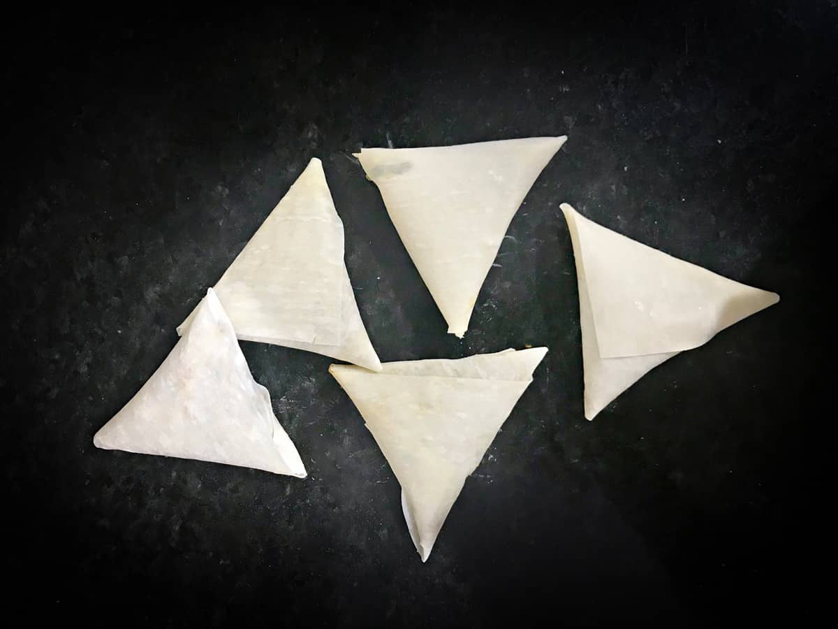 five completed wrapped keema samosa prior to frying