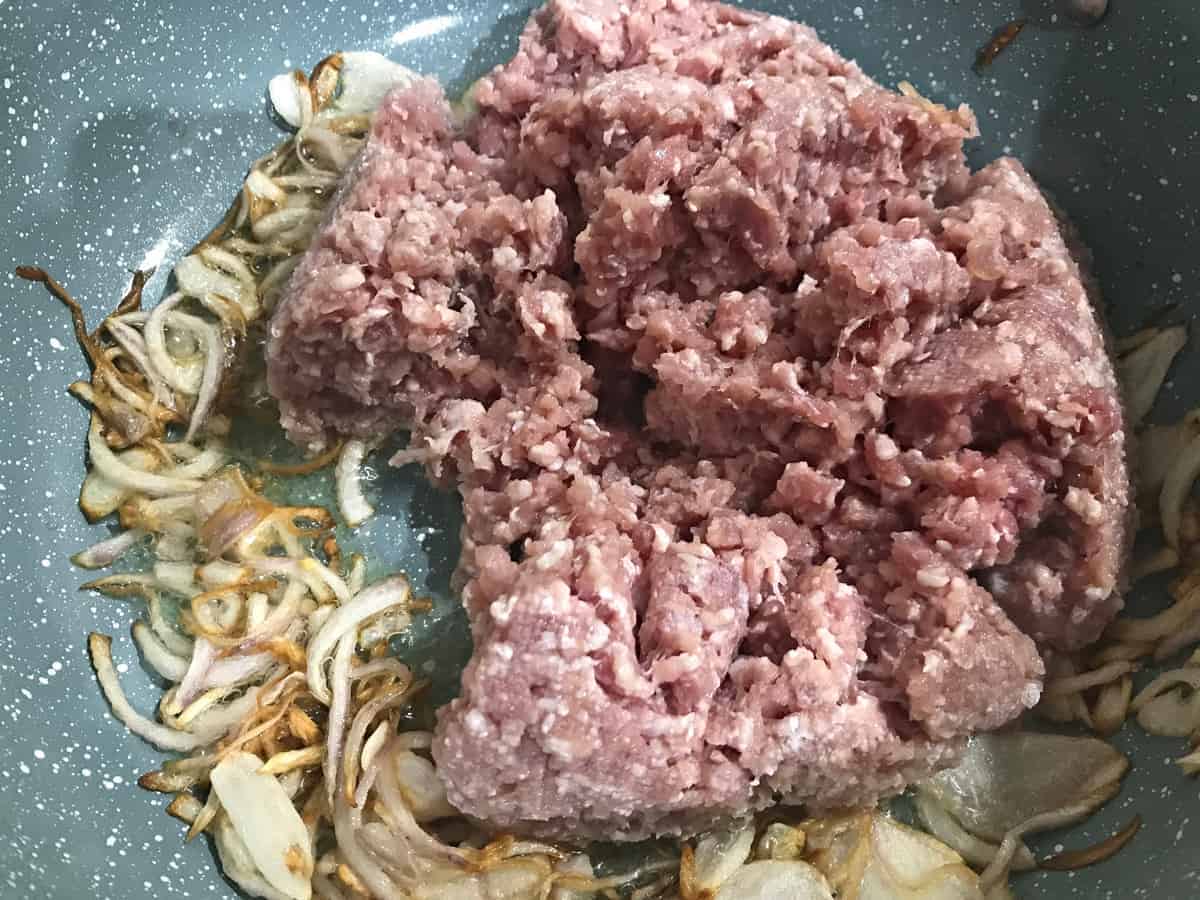 ground meat added to pan with browned onions