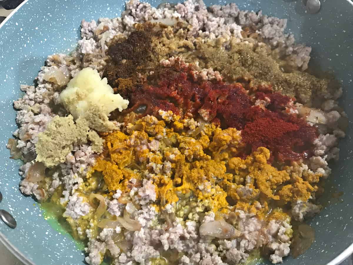 ginger garlic paste and spices added to keema meat filling