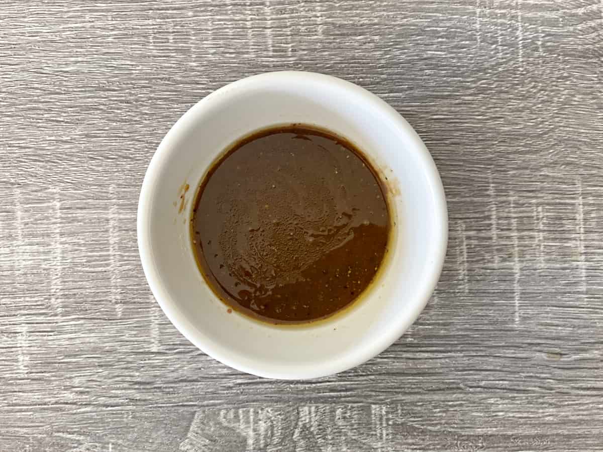 Homemade balsamic vinaigrette in a white bowl.