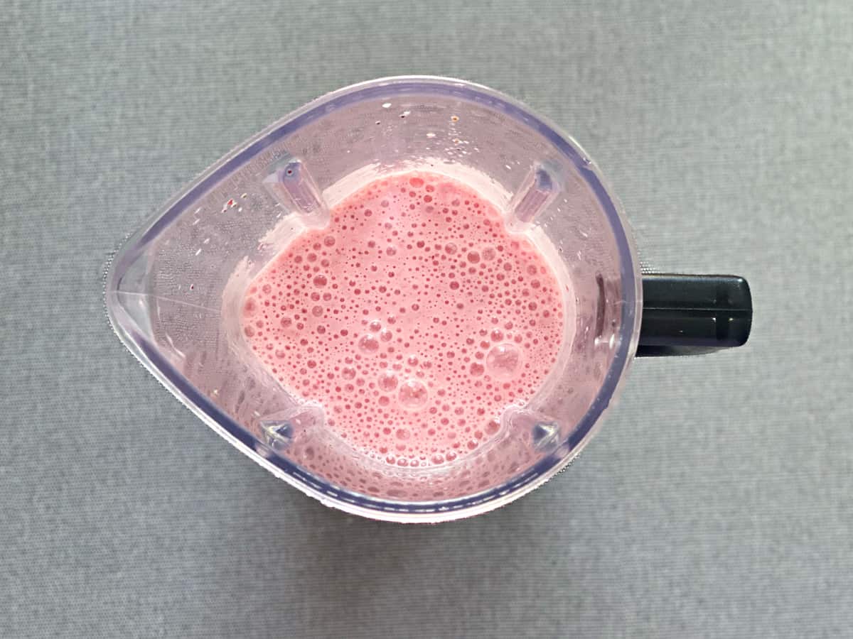 blended strawberry smoothie in blender pitcher