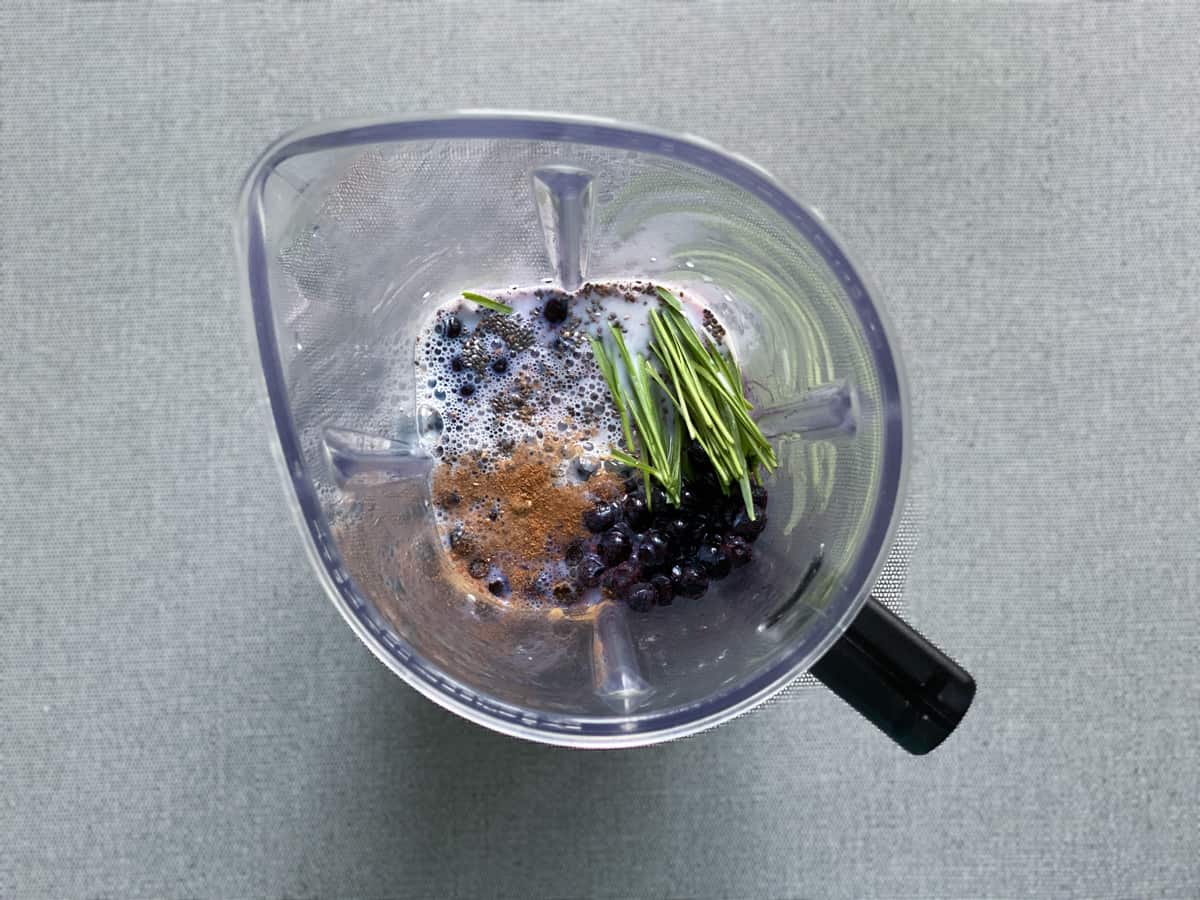 ingredients for blueberry chia smoothie recipe in the pitcher of a blender