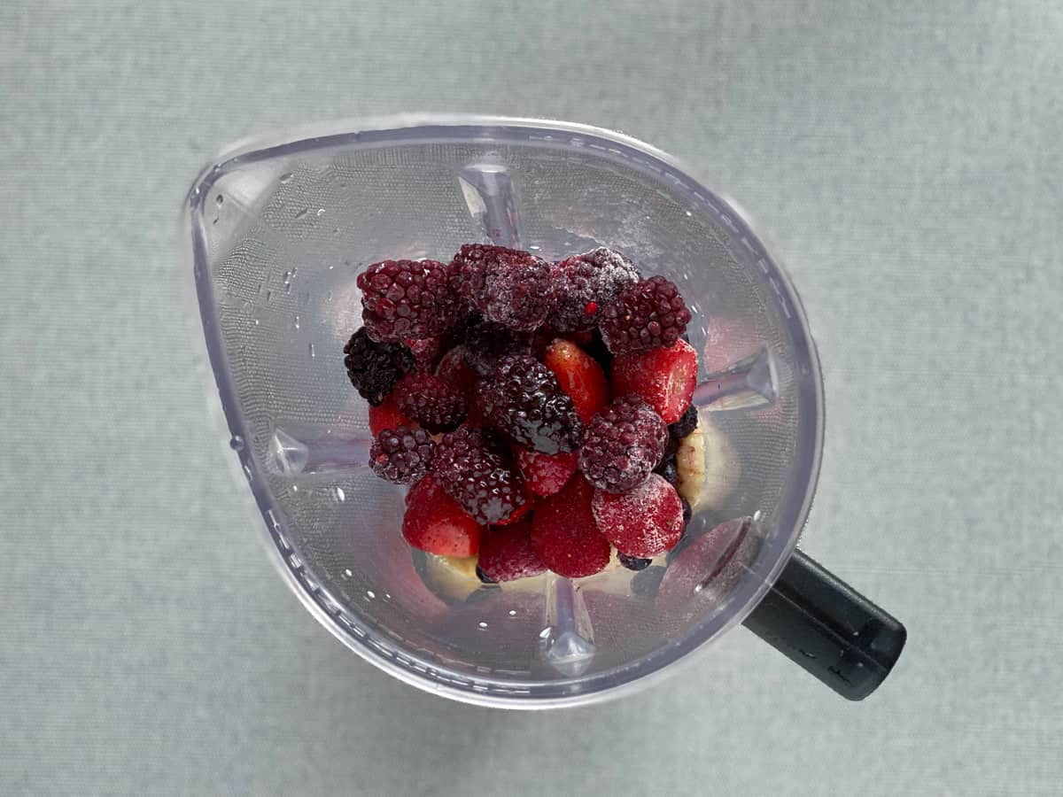 ingredients for fruits and mixed berry smoothie in a blender