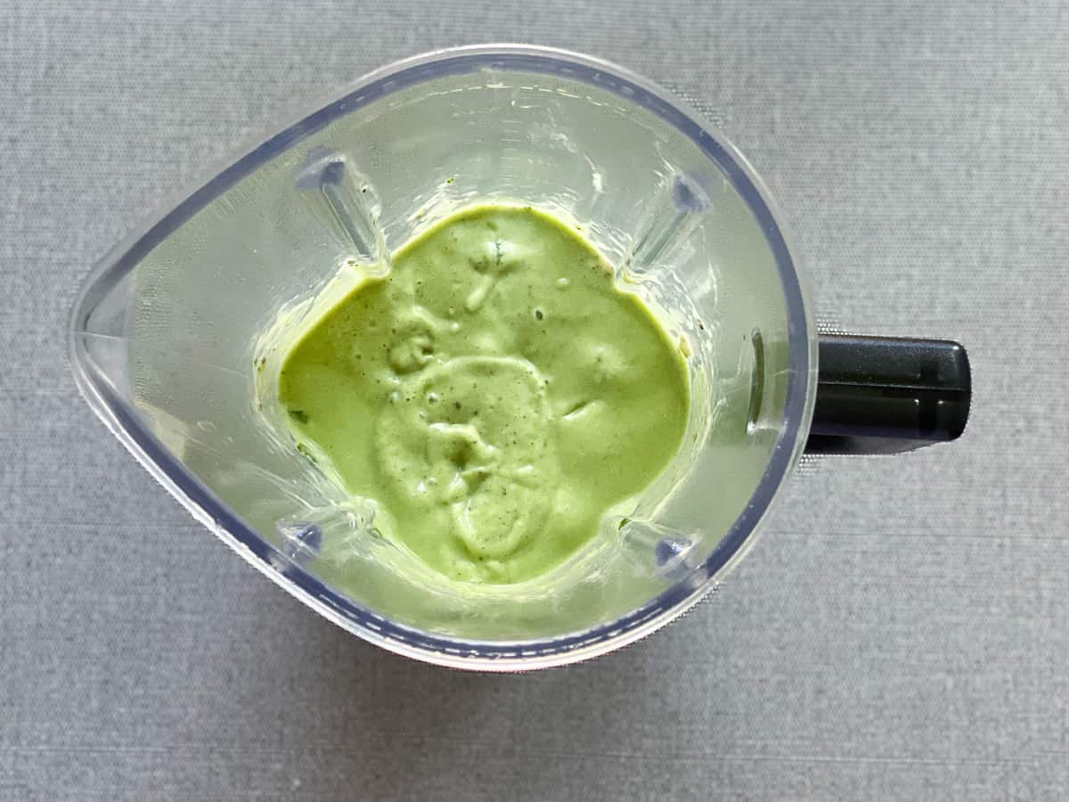 creamy avocado smoothie in a blender pitcher after blending