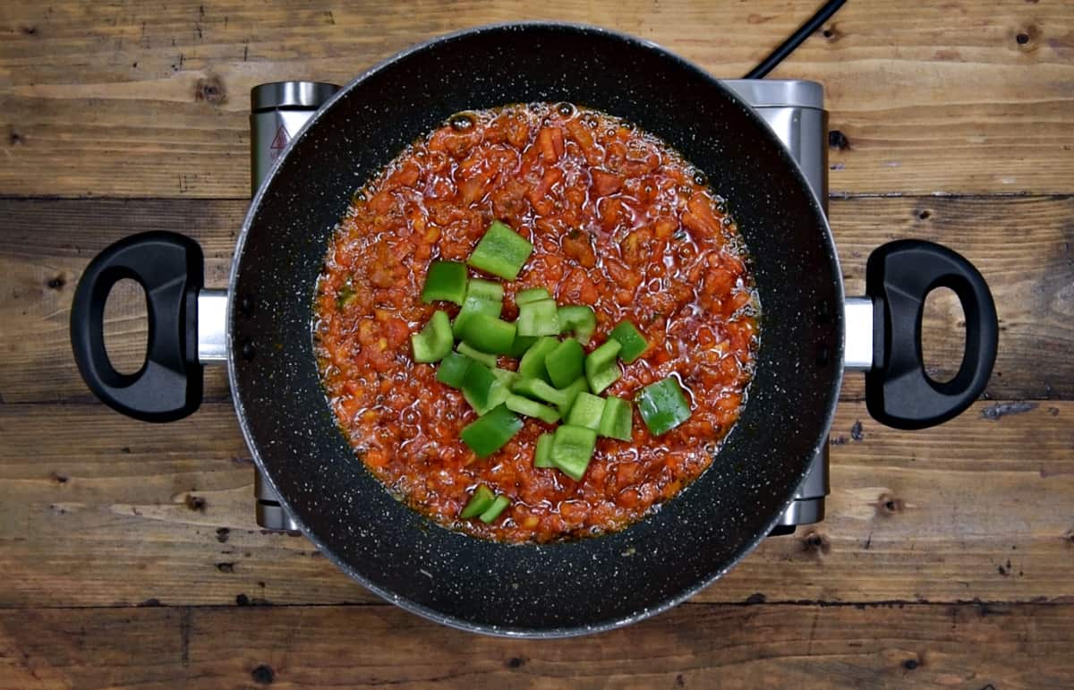 cubes green pepper added to pan with onion tomato masala