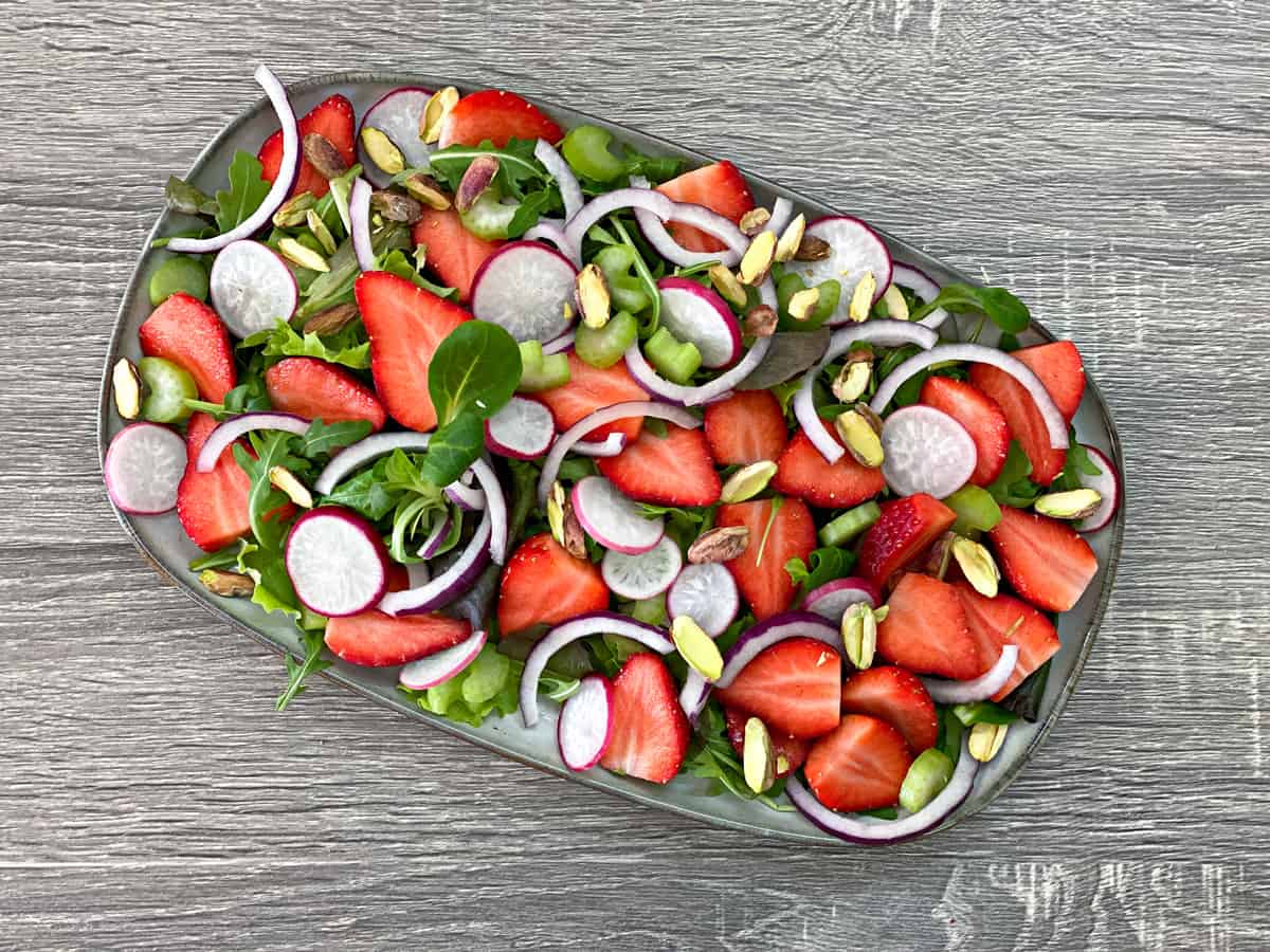 sliced onions, sliced radishes, sliced celery and roasted pistachios added to salad