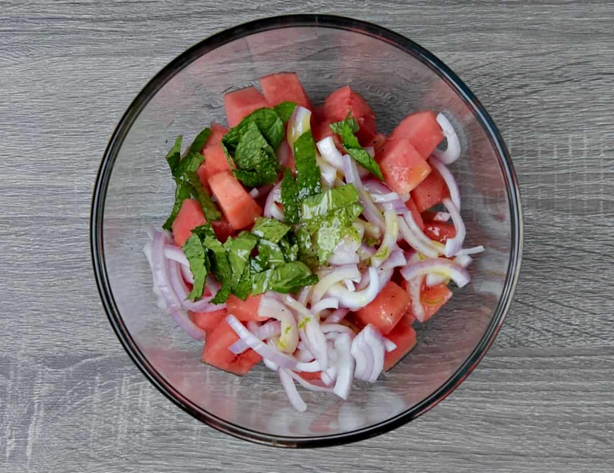 watermelon feta mint salad ingredients in a mixing bowl prior to tossing