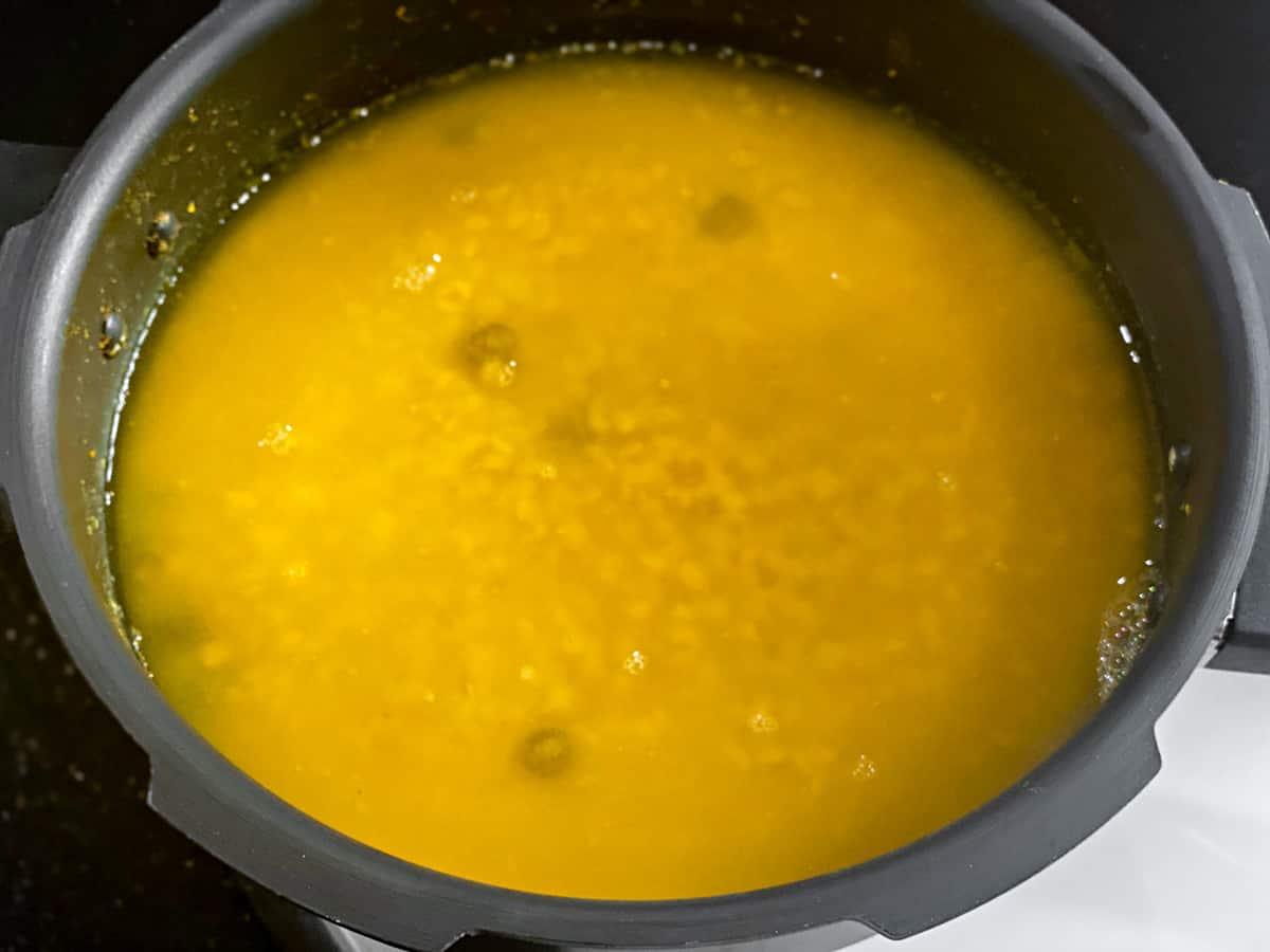 The boiled yellow lentils in a pressure cooker. 