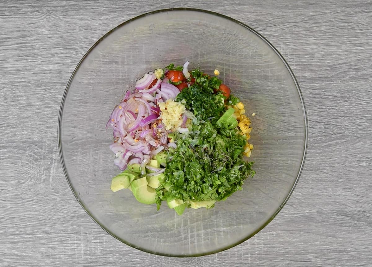 sliced onion, chopped cilantro, parsley, minced garlic, seasonings, and olive oil added in bowl