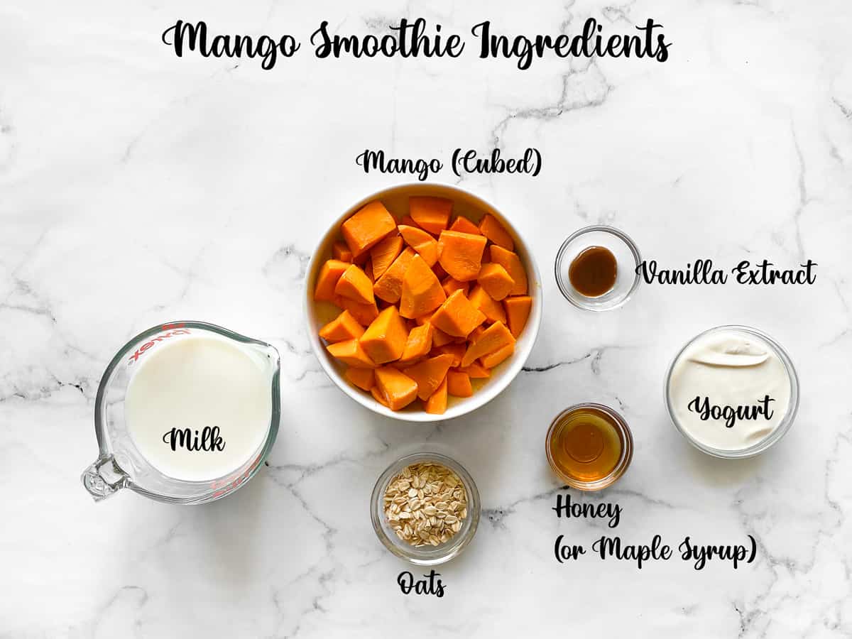 mango oat yogurt smoothie recipe ingredients measured out on a white table