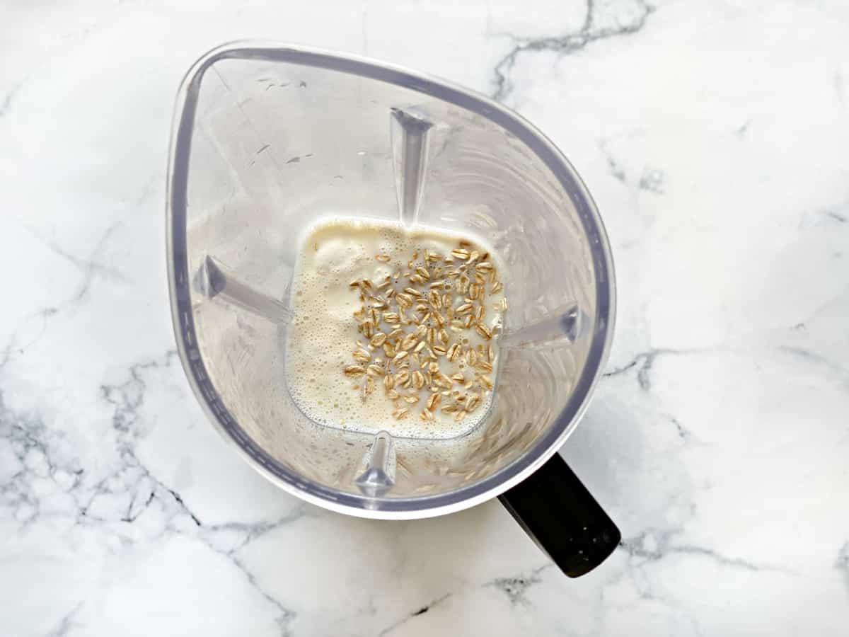 oats and milk soaking in blender pitcher