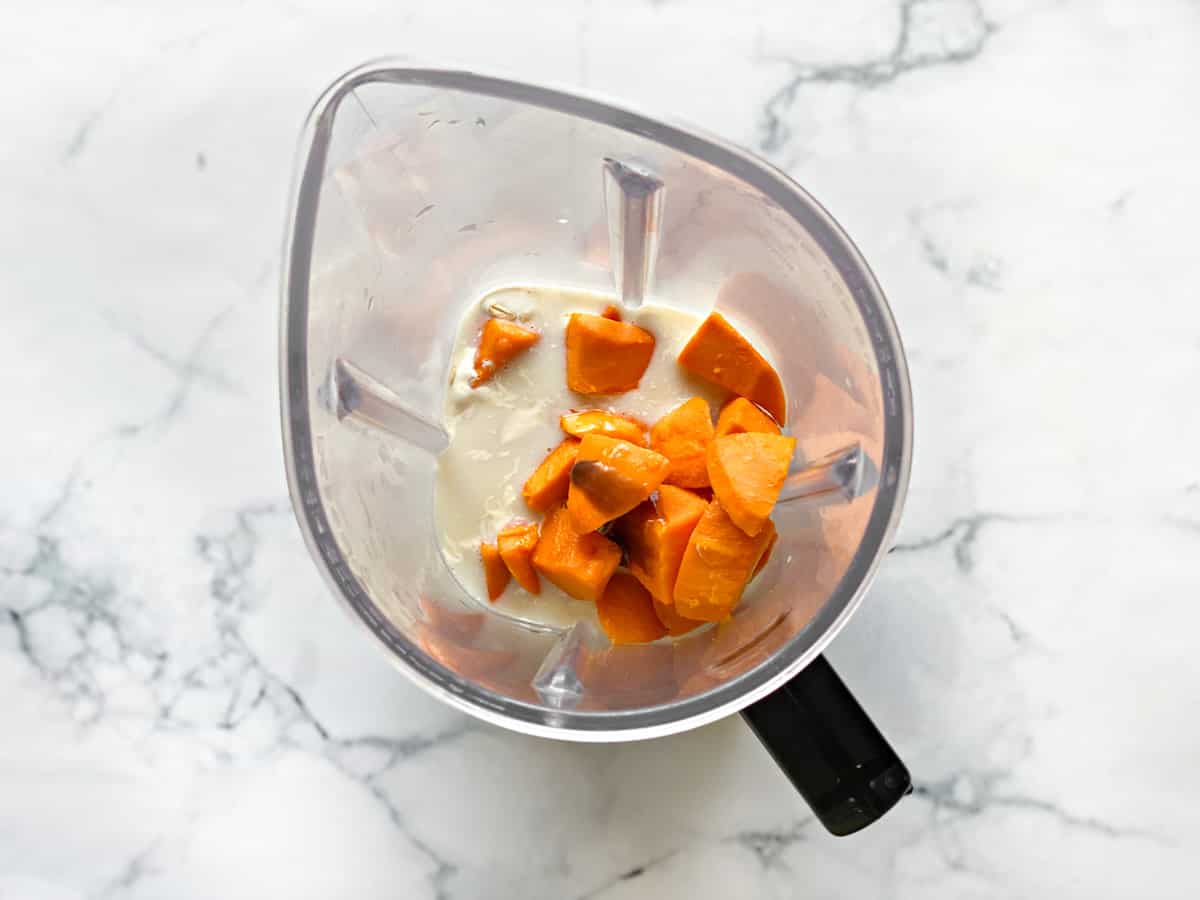 mangos and yogurt added to blender pitcher