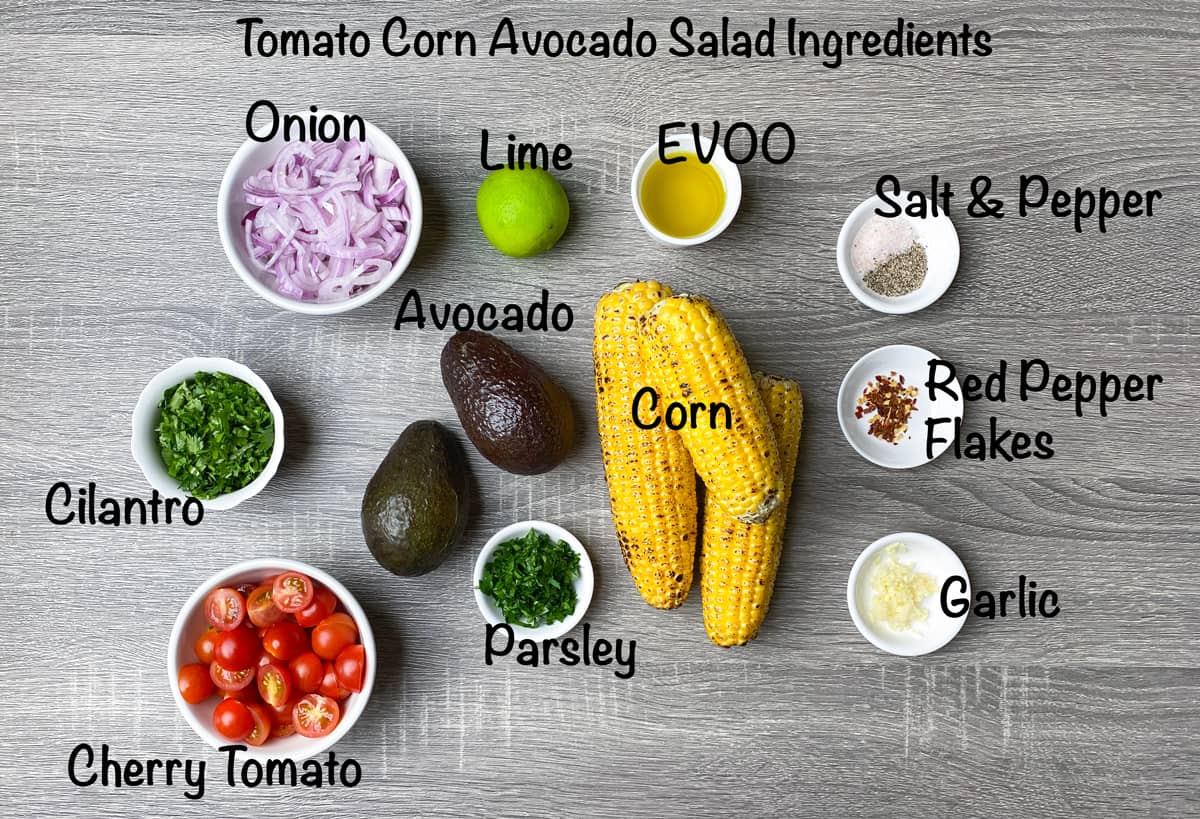 ingredients for avocado corn salad recipe placed in bowls and laid on grey table