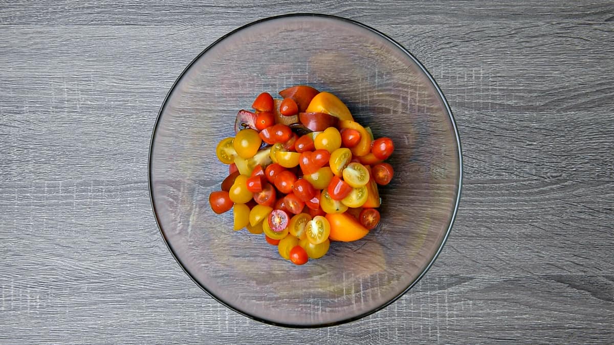 sliced tomatoes and halved cherry tomatoes in a bowl