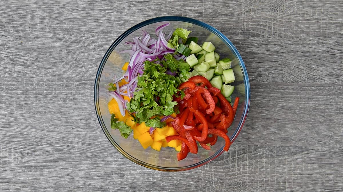 remaining veg added to mixing bowl with lettuce and mango